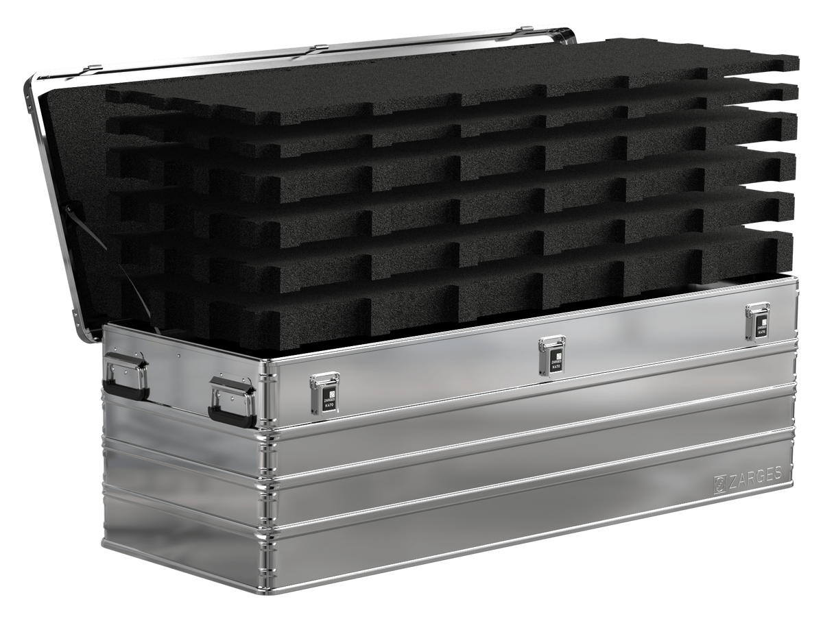 ZARGES K470-40875 case open with stacked layers of black pick-and-pluck foam rising out of the base