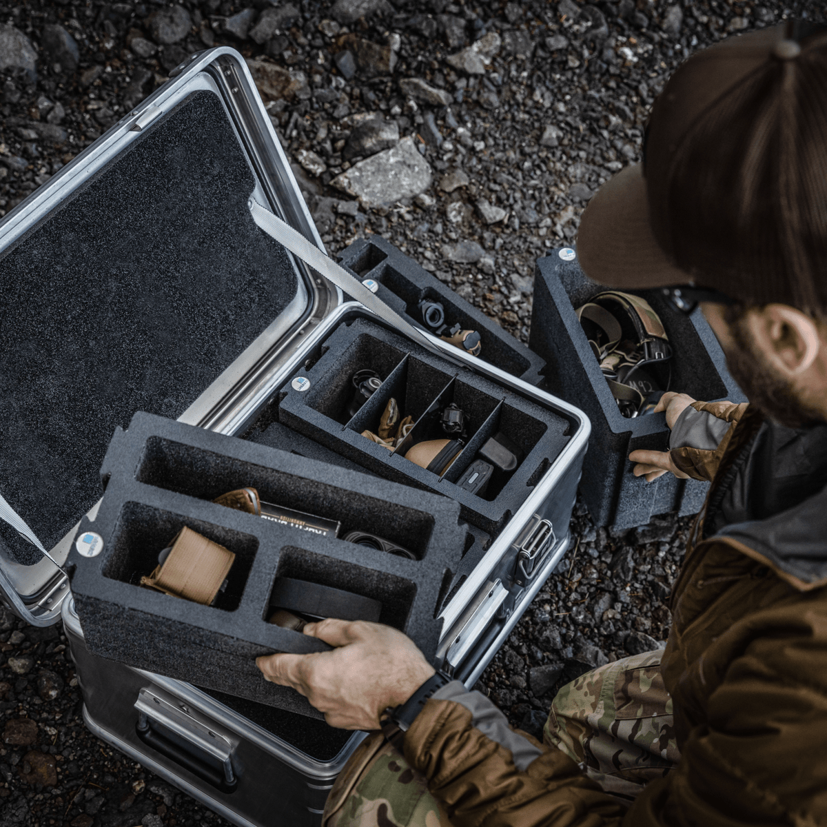 Angler lifting ZARGES Chameleon Double Wide foam modules out of an open case on rocks