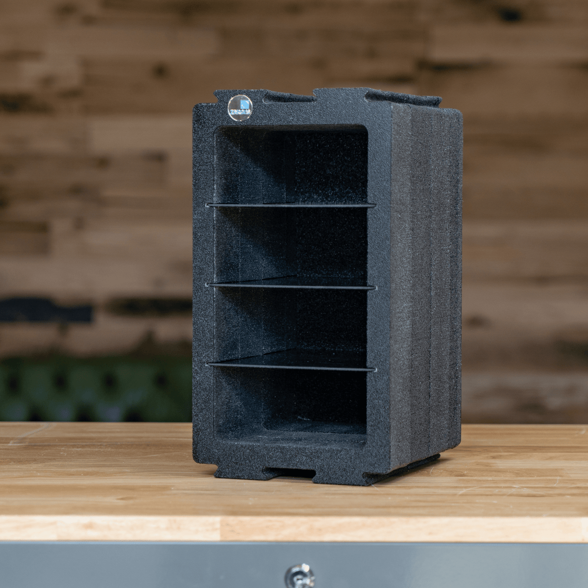 ZARGES Chameleon Module - Double Wide with Dividers upright on a wooden counter against a plank wall