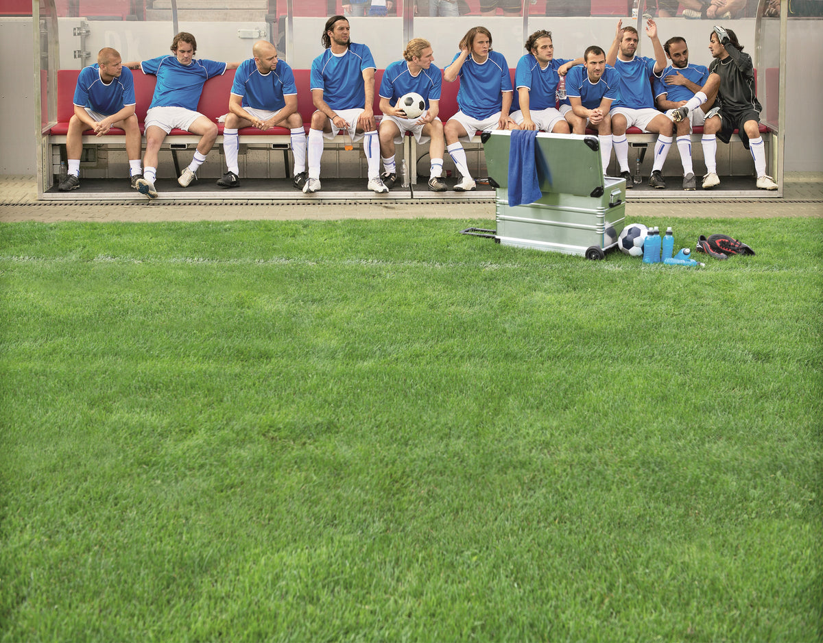 Soccer team on the bench with an open ZARGES K424 XC-41812 case at the edge of the pitch