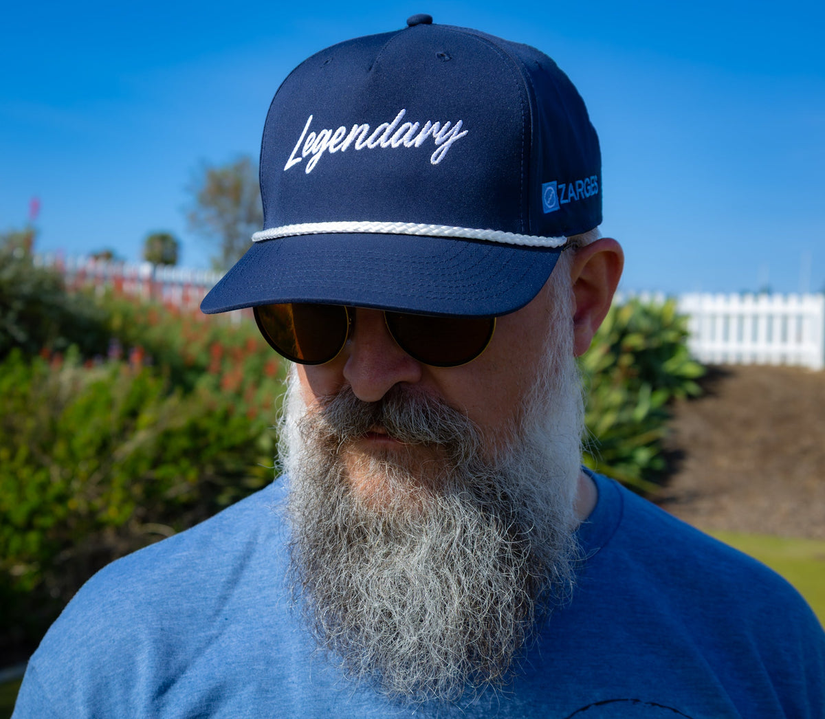 Bearded man in sunglasses wears the ZARGES Legendary Navy Blue Rope Hat, front view outdoors