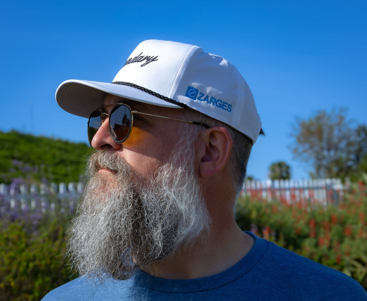 Side profile of a man in the ZARGES Legendary White Rope Hat, blue ZARGES logo on the side panel
