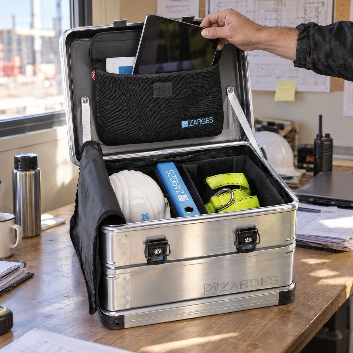 ZARGES case with the lid pocket holding a tablet and documents