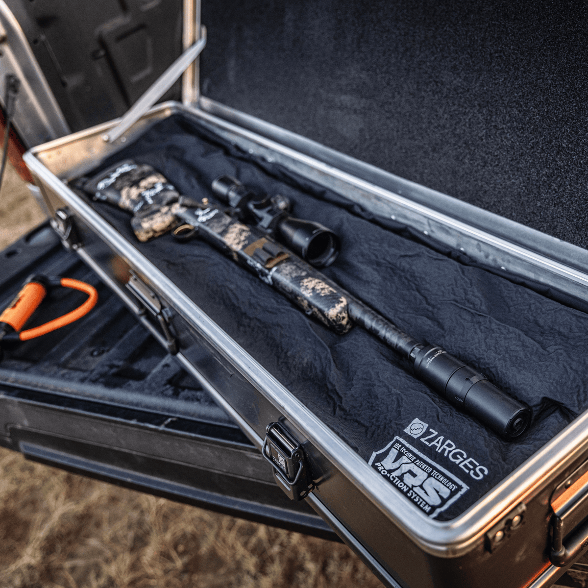ZARGES Matte Black Single Long Rifle KOR Kit holding a camo scoped rifle in an open case on a tailgate