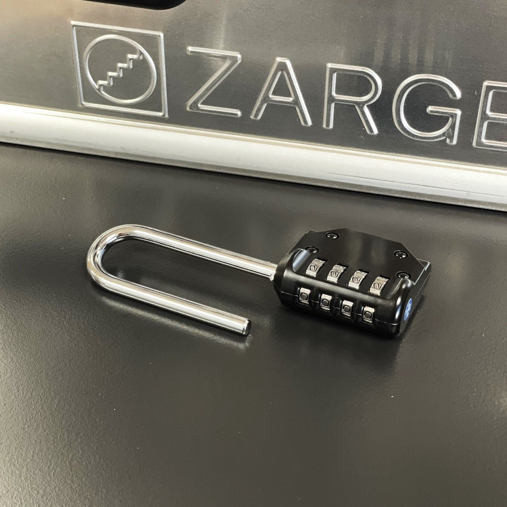 ZARGES Shackle Lock with its shackle open, lying in front of an embossed ZARGES logo