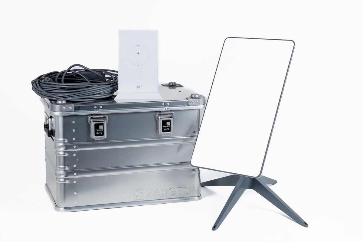 ZARGES Starlink Small Shuttle Case with a Starlink dish, router and coiled cable set beside and on top