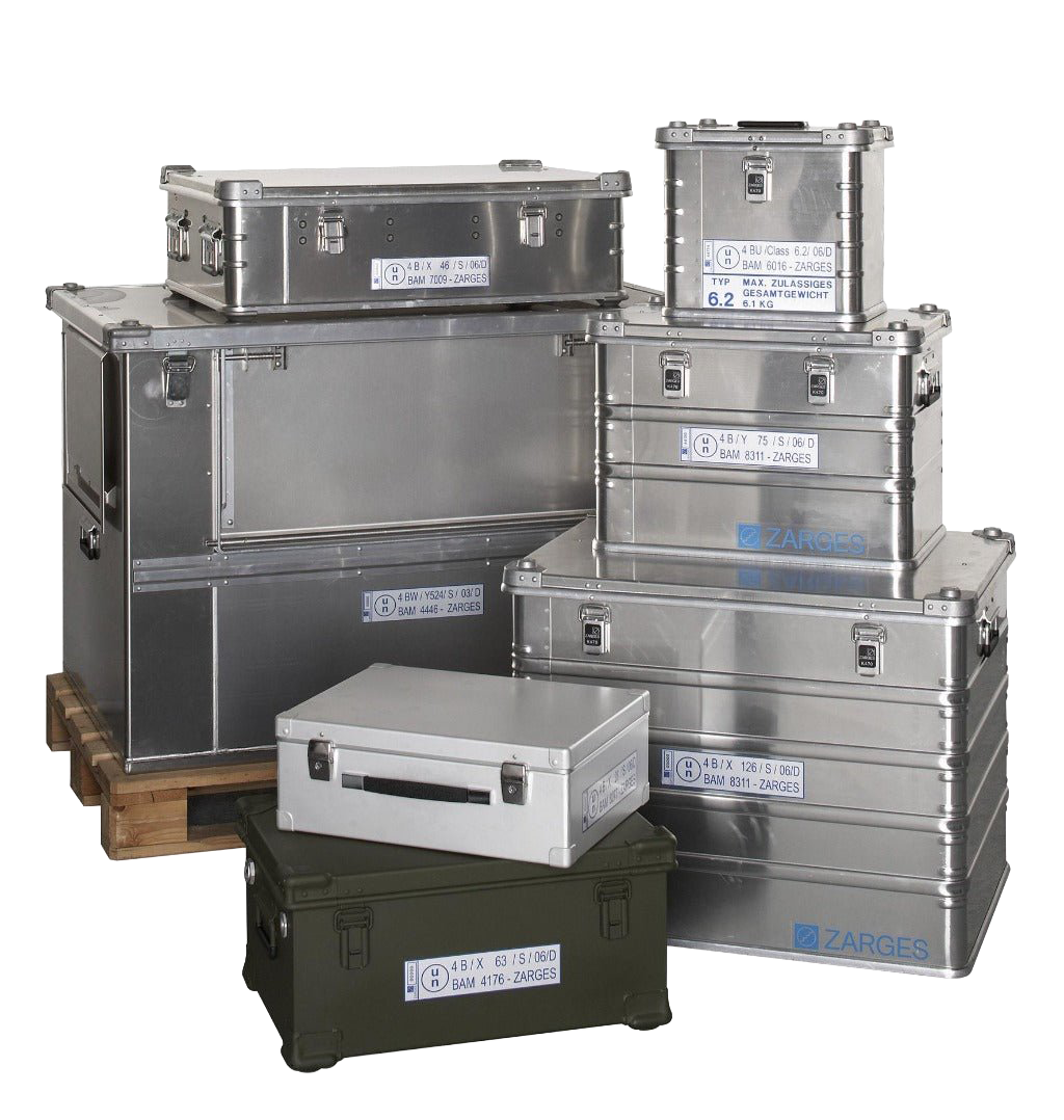 Assorted ZARGES UN-marked hazardous materials cases in silver and olive, stacked on and beside a pallet