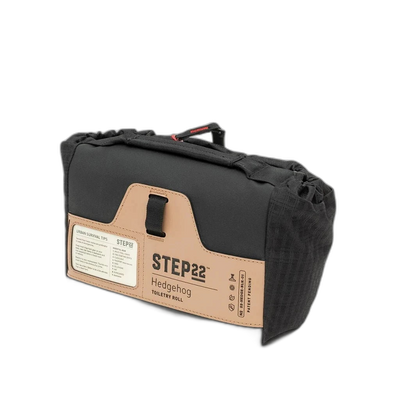 Step 22 Hedgehog Toiletry Roll, black, rolled up with tan product label and carry handle