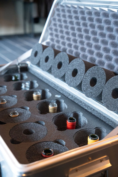 Close-up of the ZARGES 12 Bottle Wine Case foam, bottle necks in round pockets and foam collars in lid
