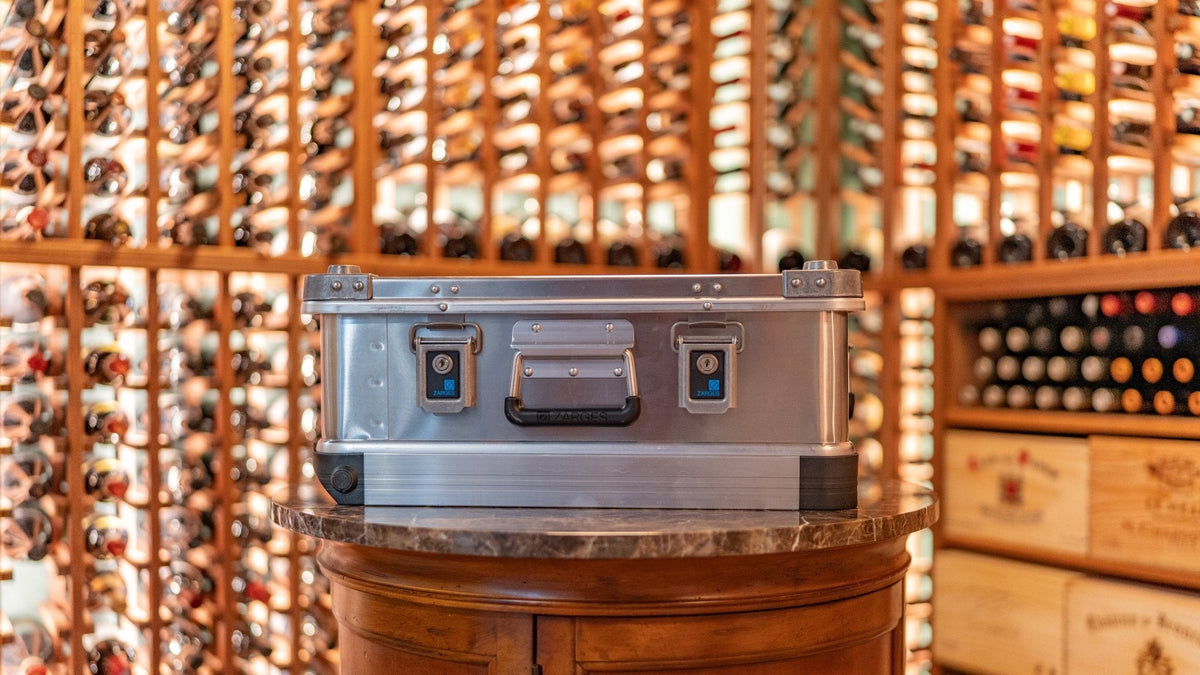 ZARGES 3 Bottle Wine Case closed on a pedestal in a wine cellar, front latches and handle
