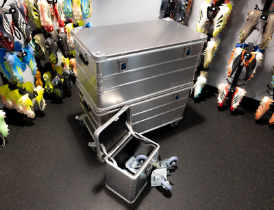 ZARGES Caster Storage Case with casters spilling out, in front of stacked ZARGES cases on wheels
