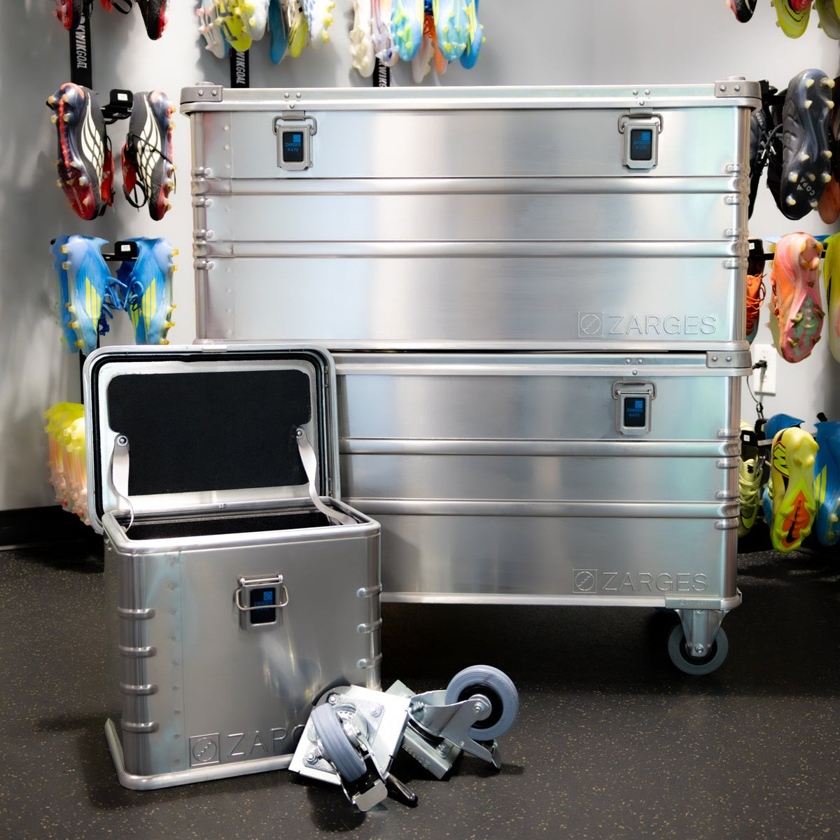 ZARGES Caster Storage Case open beside two large ZARGES cases, one on casters, in a cleat-lined shop
