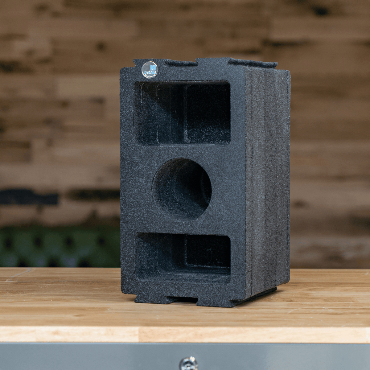 ZARGES Chameleon Module - Double Wide Camera upright on a wooden counter against a plank wall