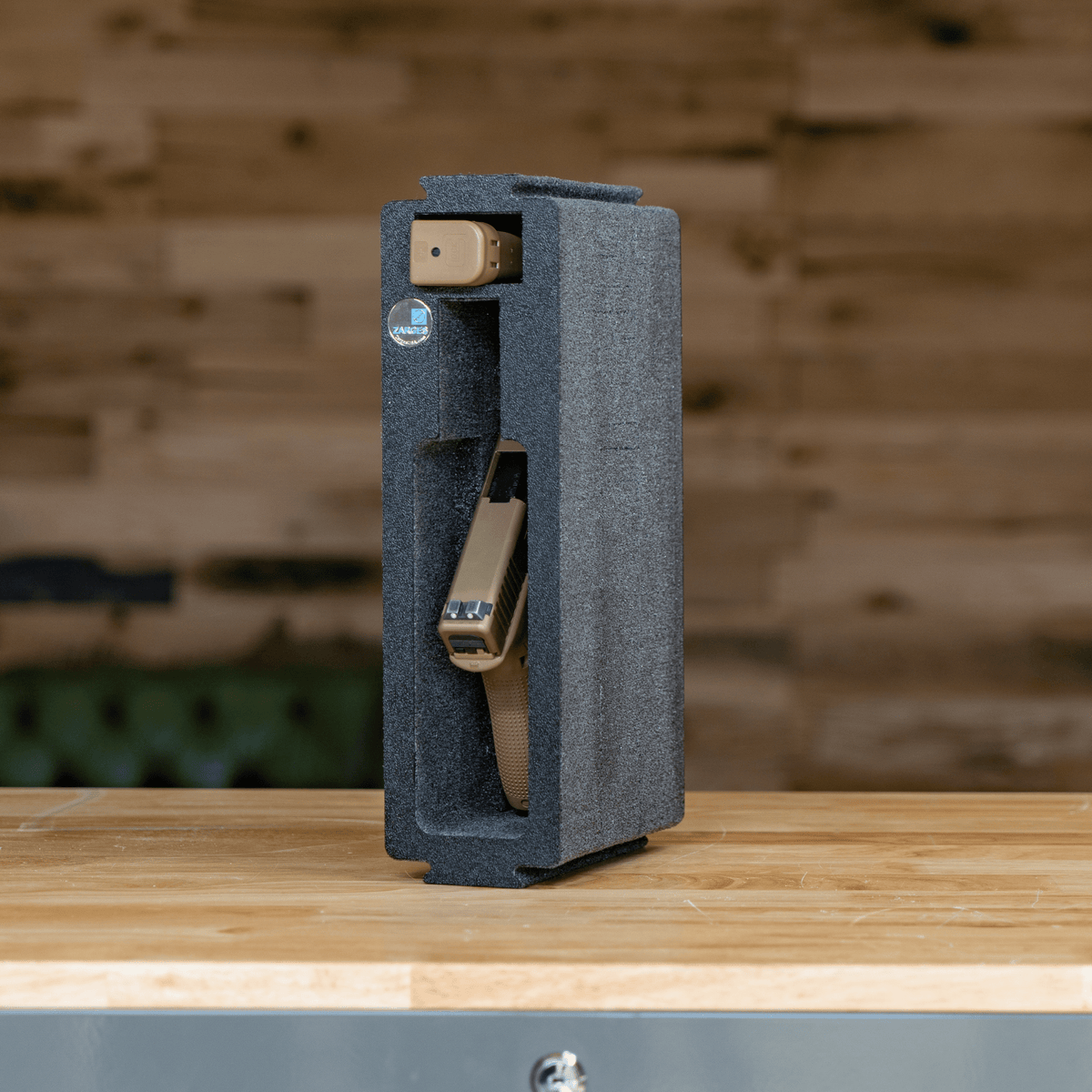 ZARGES Chameleon Module - Single Pistol standing on a wooden bench, holding a tan pistol and magazine