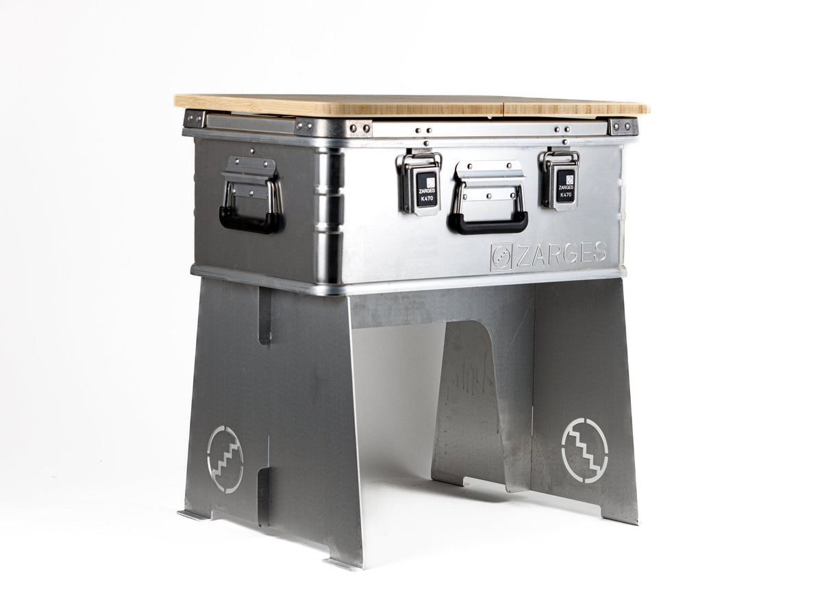 ZARGES Collapsible Case Stand holding an aluminum case topped with a wood board as a camp table