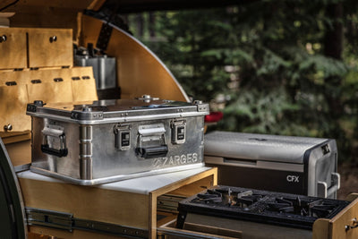 ZARGES K470-40568 case on a teardrop trailer galley counter beside a camp stove and fridge