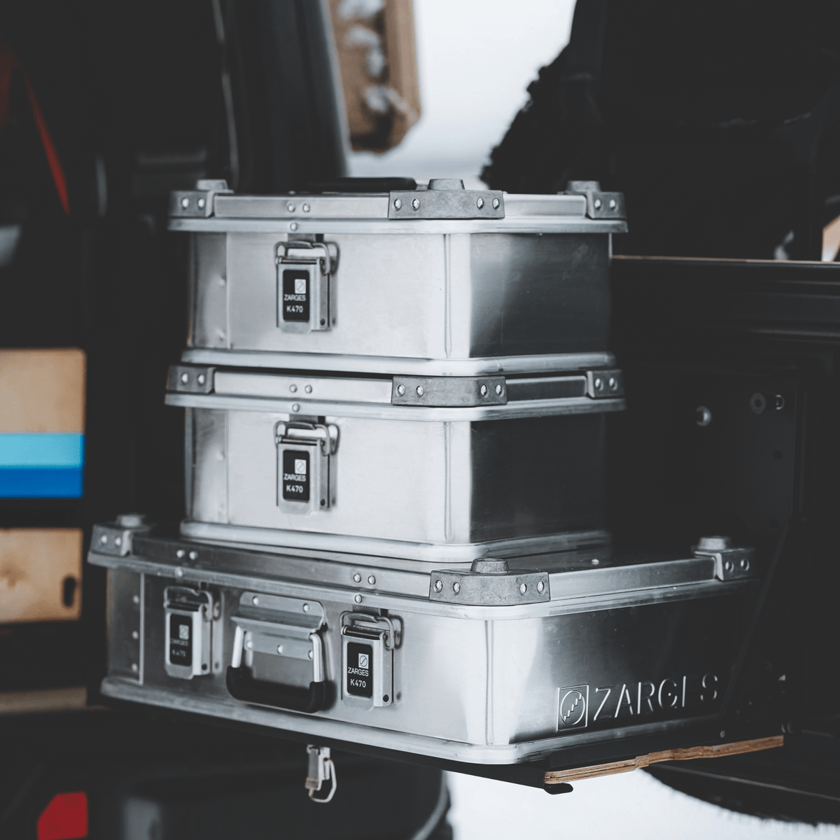 Close crop of two stacked ZARGES K470-40835 cases on a larger ZARGES case on a vehicle tray