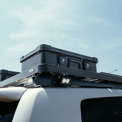 ZARGES K470-Matte Black-31013203 case strapped to a roof rack on a white SUV