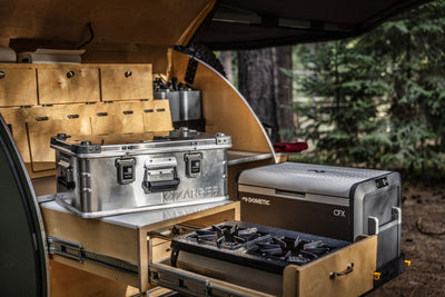ZARGES case with the Leather Handle on a teardrop trailer galley shelf above a slide-out stove