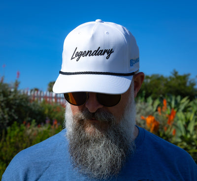 Bearded man in sunglasses wearing the ZARGES Legendary White Rope Hat, front view outdoors