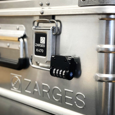 ZARGES Shackle Lock on a K470 case latch, angled view beside the ribbed case wall