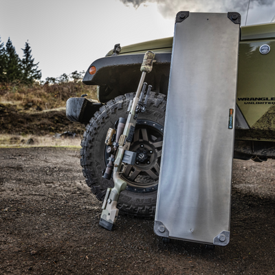 ZARGES Single Long Rifle KOR Kit case standing on end against a Jeep Wrangler tire beside a scoped rifle
