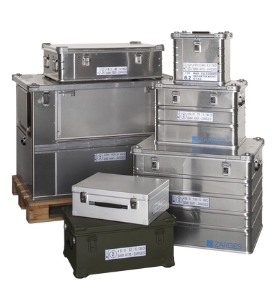 Assorted ZARGES UN-marked hazardous materials cases in silver and olive, stacked on and beside a pallet