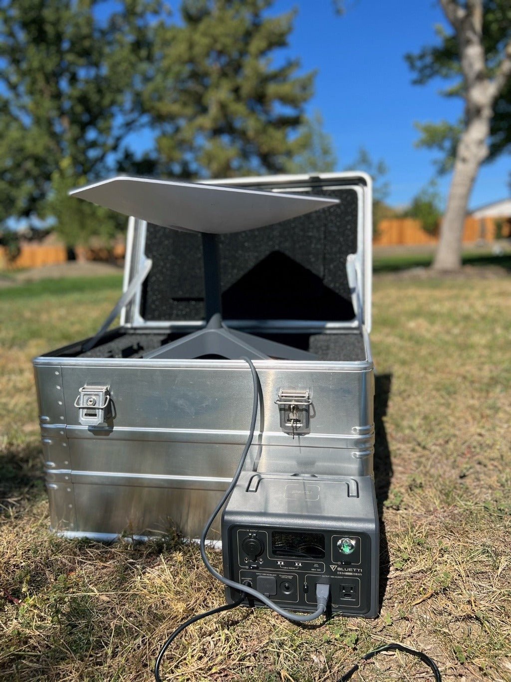 ZARGES Starlink Shuttle Case set up on a lawn, Starlink dish raised from the case and cabled to a power station