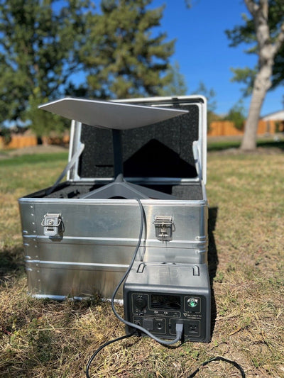 ZARGES Starlink Shuttle Case set up on a lawn, Starlink dish raised from the case and cabled to a power station